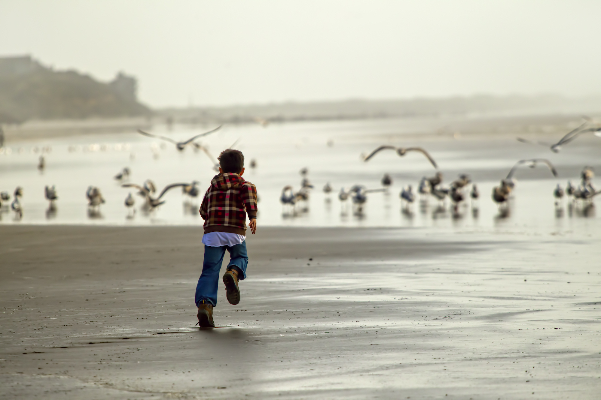 A child runs along the coast near Newport, Oregon.